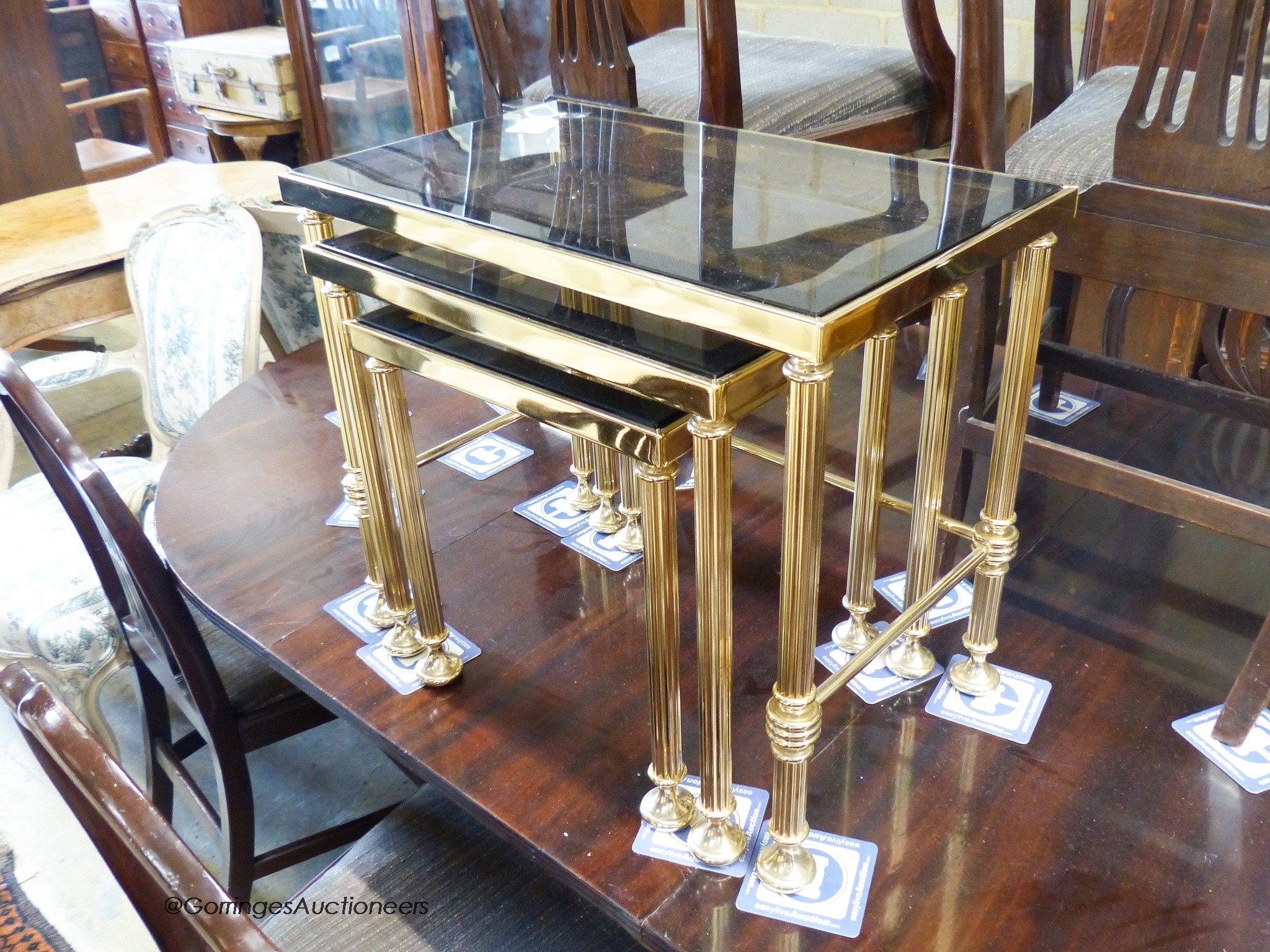 Two nests of gilt metal and glass tables and a similar coffee table.